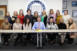 The 15 school counselors met at the Marshall County Schools Board of Education office for the proclamation signing. Seated, from left: John Marshall High School Counselor Mika Ward, Sherrard Middle School Counselor Courtney Wheeling, JMHS Counselor Mia Angalich, Marshall County Schools Student Services Director Casey Storm, JMHS Counselor Angela Curran, and JMHS Counselor Melanie Knutsen. Standing, from left: Hilltop Elementary School Counselor Shelly Behm, Cameron Elementary School Counselor Rachel Ciccone, Sand Hill Elementary School Counselor Claire Juszczak, Cameron High School Counselor Kelly Pettit, Moundsville Middle School Counselor Abby Aston, Central Elementary School Counselor Jenna Dompa, Glen Dale Elementary / Washington Lands Elementary School Counselor Amy Tucker, McNinch Primary School Counselor Jennifer Pickett and Center McMechen Elementary School Counselor Jennifer Wharton